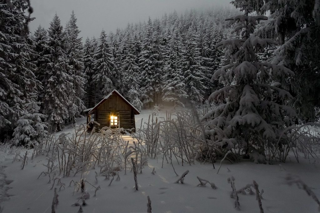 log cabin in winter forest